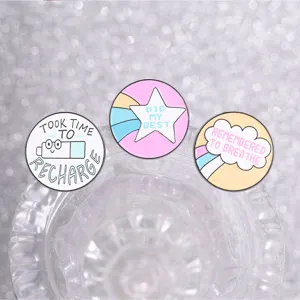 Close-up of mental health healing enamel pins with inspirational English quotes