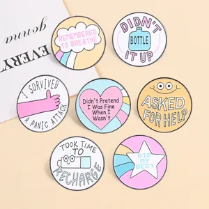 Close-up of pastel mental health healing enamel pins with positive quotes