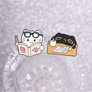 Close-up of cute cartoon black and white cat enamel pins for student backpacks