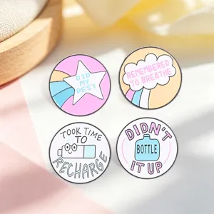 Detailed view of four mental health enamel pins with motivational quotes in macaron colors