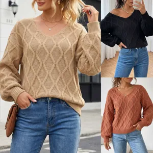 Detailed view of women's V-neck diamond knit sweater, stylish long sleeve pullover top.
