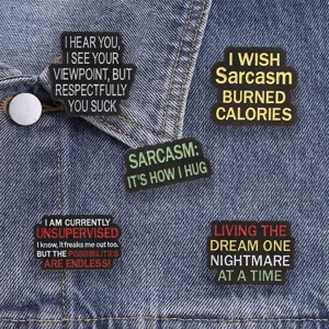 Detail of five funny sarcastic quote enamel pins on denim jacket