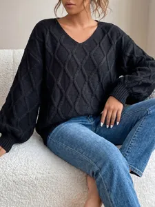 Detailed view of black V-neck cable knit sweater with diamond pattern, cozy and soft fabric.