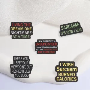 Close-up of colorful sarcastic enamel pins with funny English quotes on white background