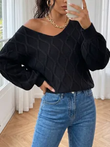 Black V-neck knitted sweater detail showing textured diamond pattern and loose long sleeves.