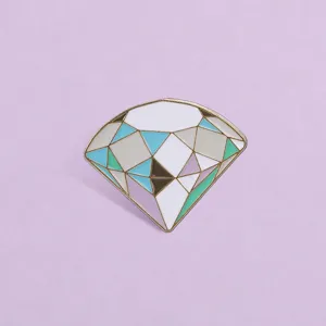 Detailed macro view of a macaron colored diamond enamel pin with geometric facets