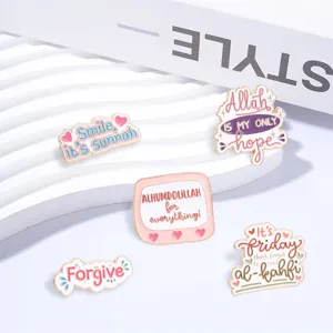 Detailed view of Islamic inspirational enamel pins featuring pink and gold accents