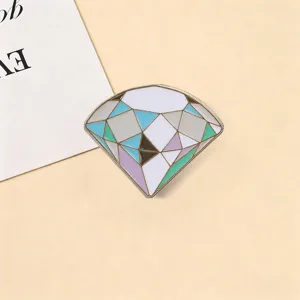 Elegant macaron colored diamond brooch with geometric facets on beige backdrop