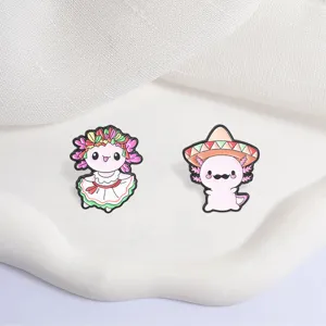 Detail view of Mexican style axolotl enamel pins with sombrero and floral dress.