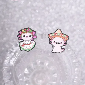 Macro view of cute Mexican style axolotl enamel pins with ethnic dress and sombrero