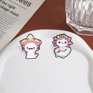 Detailed view of cute Mexican style cartoon axolotl enamel pins displayed on a white plate