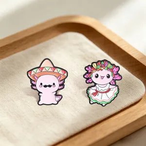 Detailed view of cute Mexican style axolotl enamel pins wearing sombrero and ethnic dress
