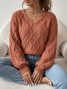 Close-up detail of women v-neck cable knit sweater in rust orange, stylish cozy knitted top.