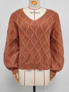 Detailed view of women rust V-neck sweater, classic diamond cable knit texture and lantern sleeves.