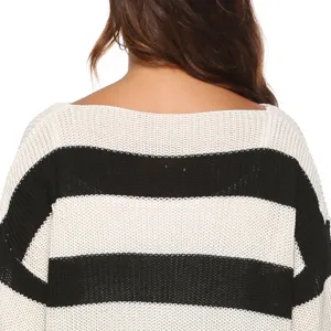 Detailed view of women's black and white striped knitted sweater, boat neck and long sleeves.