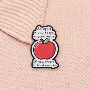 Detailed close-up of a funny red apple enamel pin featuring a witty English text quote.