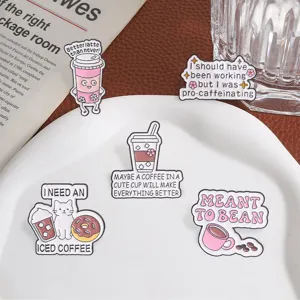 Detail of five cute coffee-themed enamel pins with puns on a white display plate