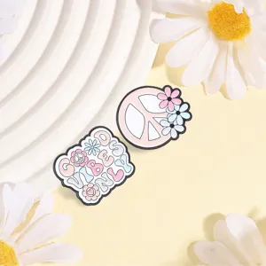 Close-up of retro hippie enamel pins with peace symbol and Good Vibes Only text.