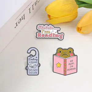 Whimsical reading frog and book themed enamel pin set for avid readers and hobbyists