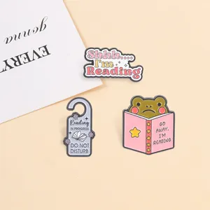 Cute funny frog enamel pin set featuring Go away I'm reading and Do not disturb text