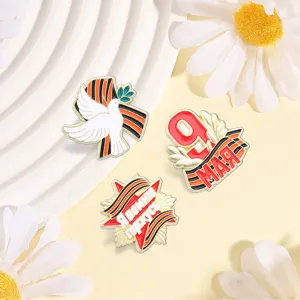 Detailed view of three Russian Victory Day enamel pins with St. George's ribbon motifs