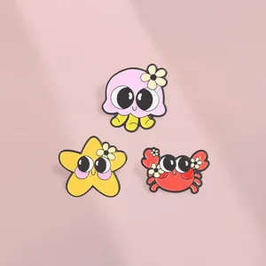 Set of cute cartoon ocean animal enamel pins featuring octopus, crab, and starfish