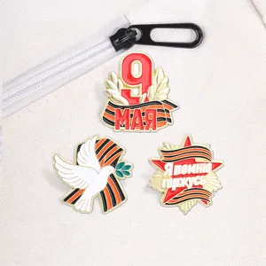 Detailed view of Victory Day pins with St. George's ribbon and peace dove on white bag