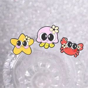 Close-up detail of cute cartoon octopus crab and starfish enamel pins on a glass