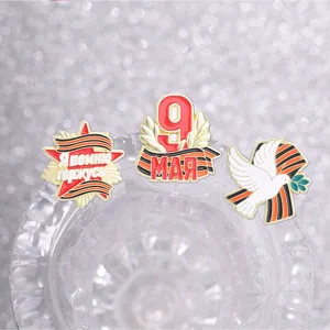 Macro detail of Victory Day commemorative brooches with peace dove and ribbon icons.