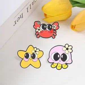 Cute cartoon marine animal enamel pins featuring a crab, starfish, and pink octopus.