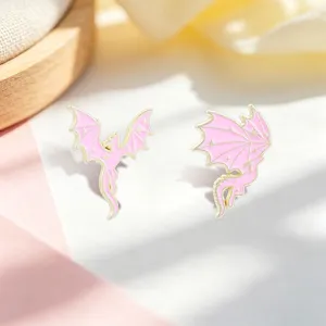 Dreamy pink and gold winged dragon enamel pins with delicate star patterns for backpacks