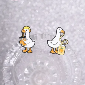 Detailed view of two cute white duck enamel pins drinking juice and soda.