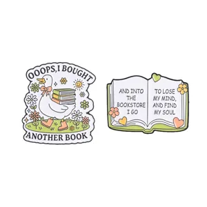 Whimsical set of two enamel pins for book lovers featuring a duck and an open book