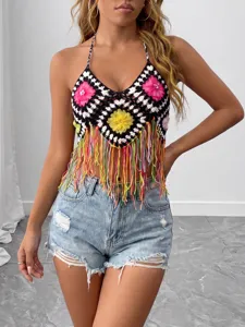 Handmade crochet halter top detail featuring colorful floral patches and playful fringe accents.