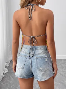 Hand-crocheted halter crop top featuring colorful fringe and stylish black and white ties.