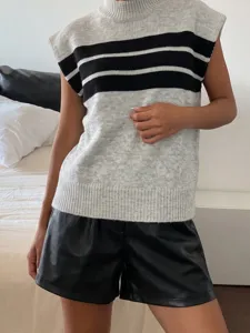 Detail view of a women's striped high-neck knit vest in grey and black colors