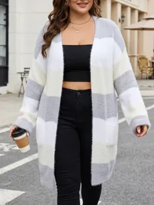 Plus size open front long sleeve striped cardigan sweater coat worn by model in street detail view.
