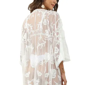 Women's white sheer lace beach cover-up kimono cardigan for summer vacation holiday swimwear.