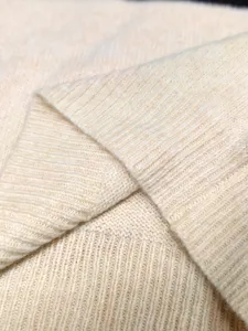Close-up macro view showing the soft ribbed texture of a cream knitted vest top
