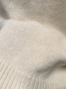 Vista de detalle en primer plano de la suave textura de tejido de lana, mostrando material cálido.