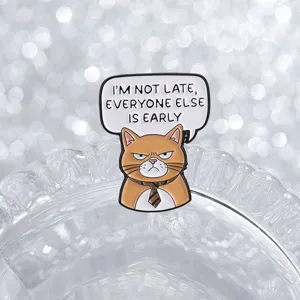 Detalle de un divertido broche esmaltado de gato naranja con una frase de oficina