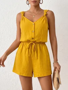Tuta estiva testurizzata con spalline annodate in giallo unito, ideale per le vacanze.