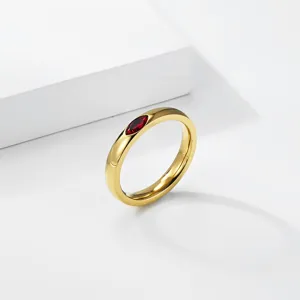 Detailed view of an elegant 18K gold plated titanium steel ring with marquise red gemstone