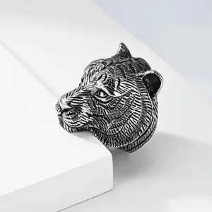 Detailed shot of men's stainless steel retro tiger head ring, punk style statement fashion jewelry.