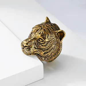 Close-up of vintage gold tiger head ring in stainless steel, showing intricate carved design.