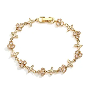 Detailed view of a gold clover and butterfly bracelet with sparkling inlaid stones