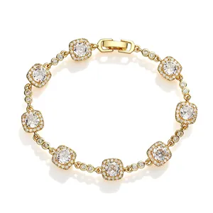 Detail view of gold-tone bracelet featuring square elements with sparkling clear stones