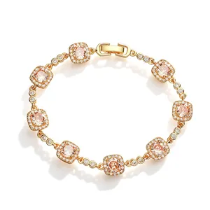 Close-up of gold-plated bracelet with cushion-cut pink stones and pavé crystals