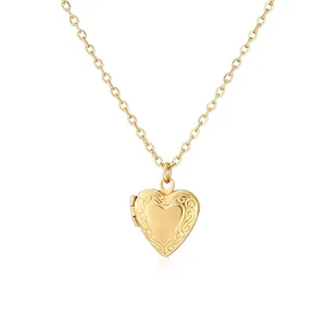 Vintage gold heart-shaped locket necklace featuring intricate floral engraving on surface