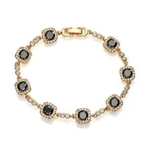 Detailed view of gold copper bracelet with square black and white crystals